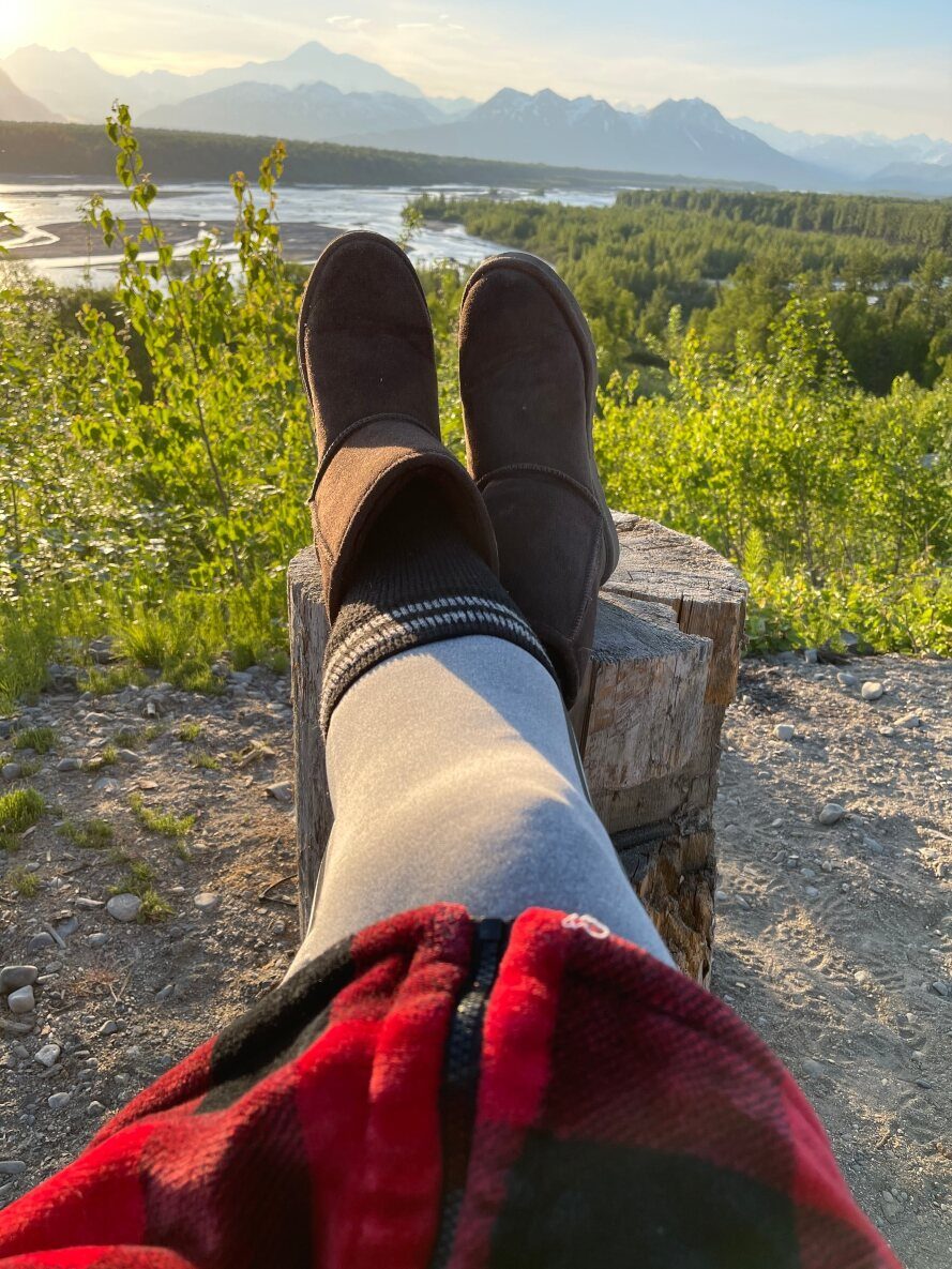 Boots up on a stump overlooking the river valley